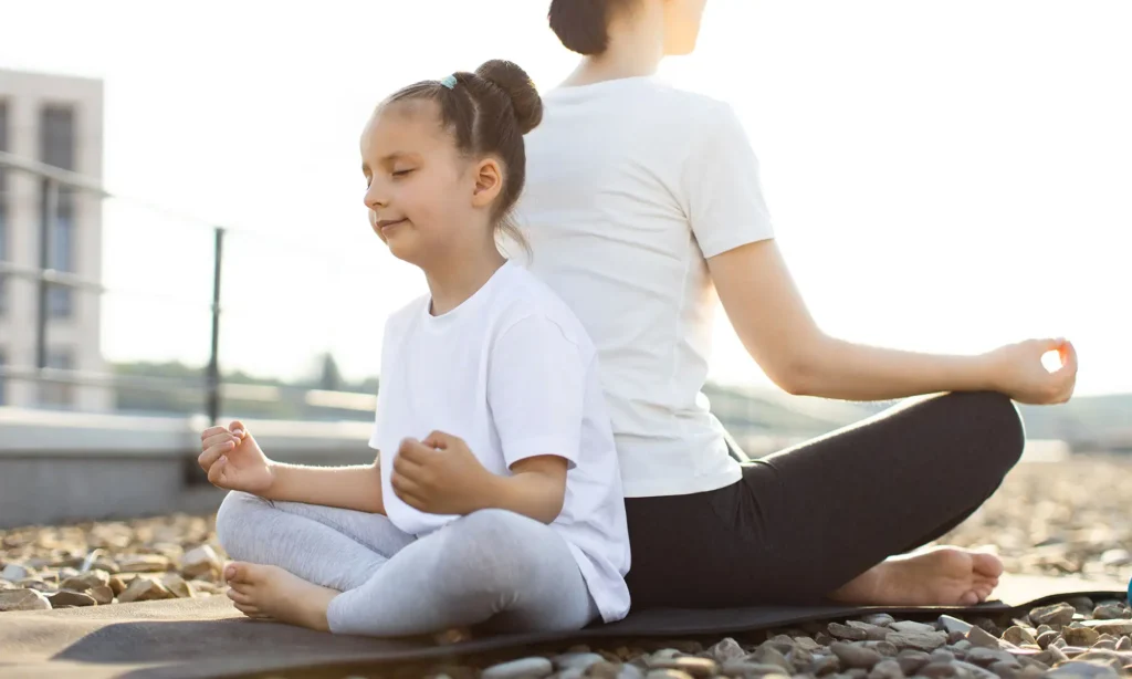 A mother and daughter meditating together, illustrating Mindfulness-Based Family Therapy at Transformation Health Services in Virginia Beach, VA