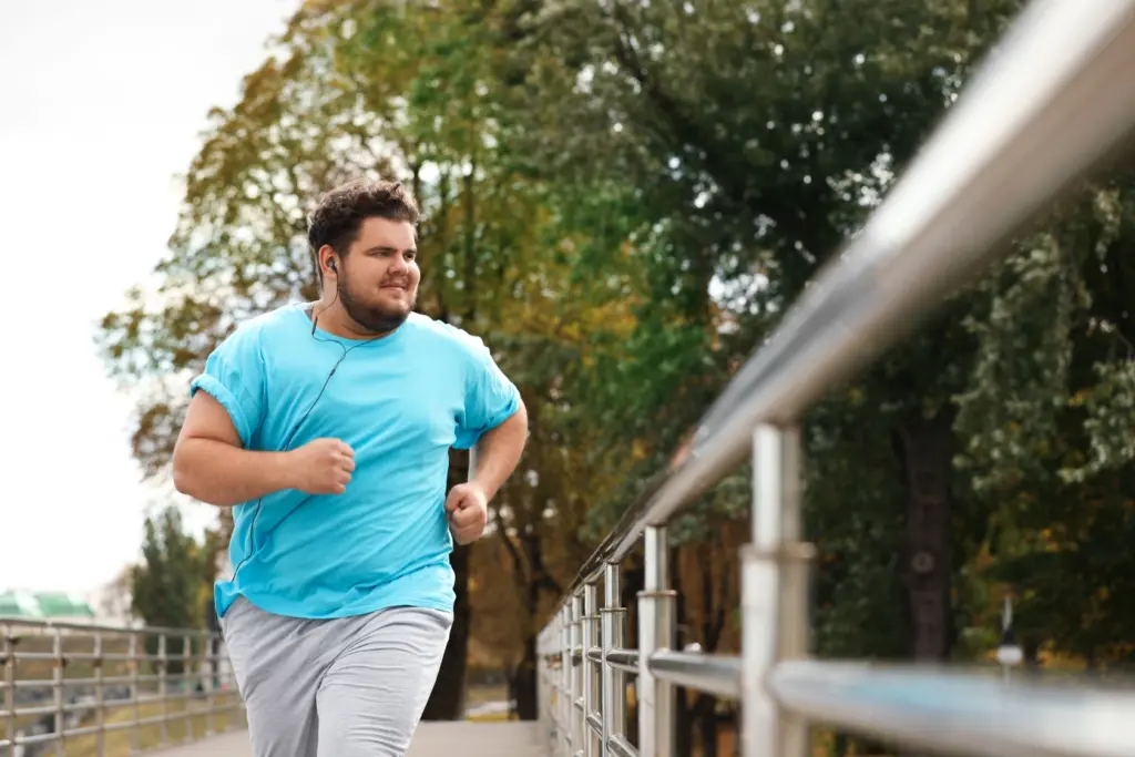 A man is jogging outside and looking confident with Medical Weight Management at Transformation Health Services