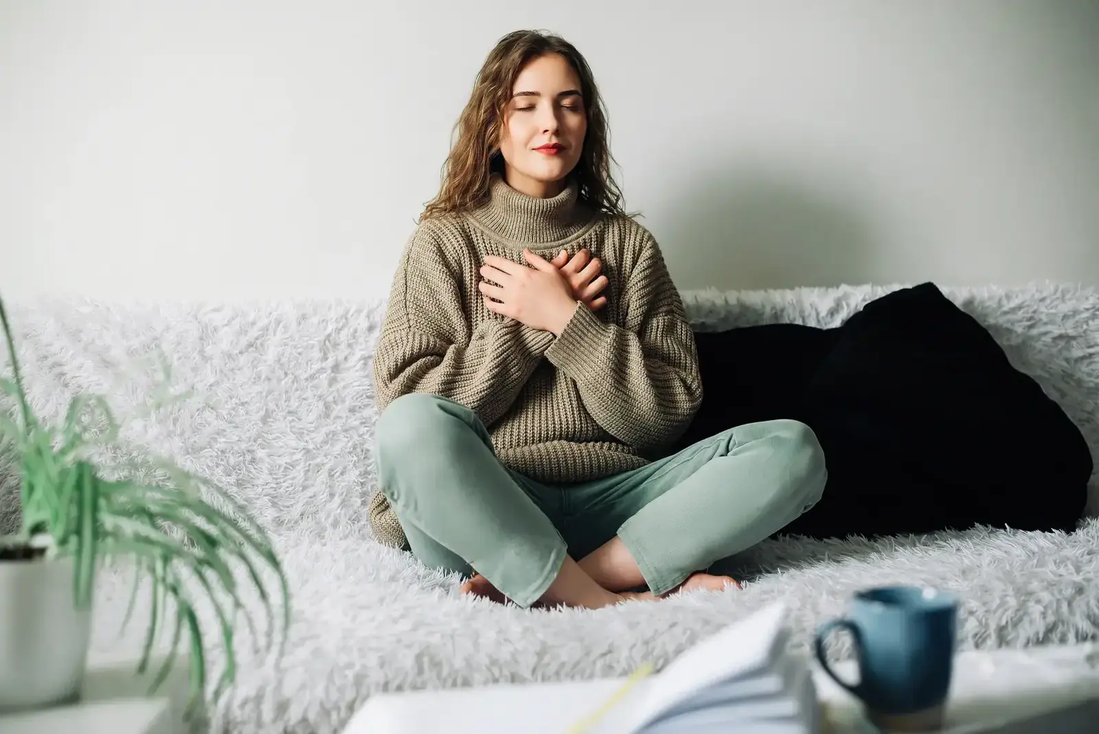 A Female with closed eyes and hands on chest