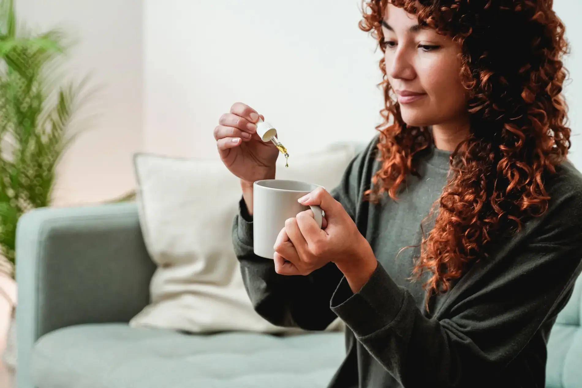 A Young woman adding a drop of medicine to a cup | Alternative Medicine at Transformation Health Services in Virginia Beach, VA