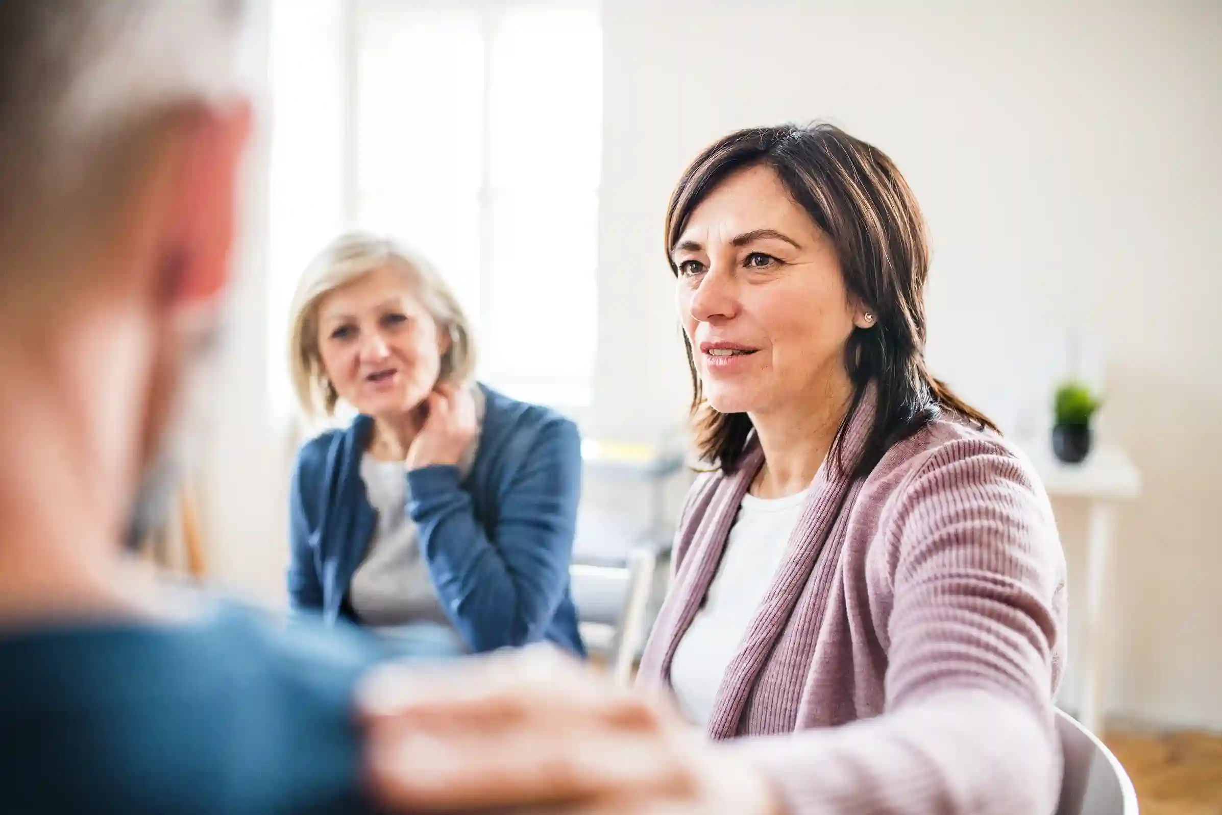 A woman supporting another person, while on Support Group Therapy at Transformation Health Services in Virginia Beach, VA