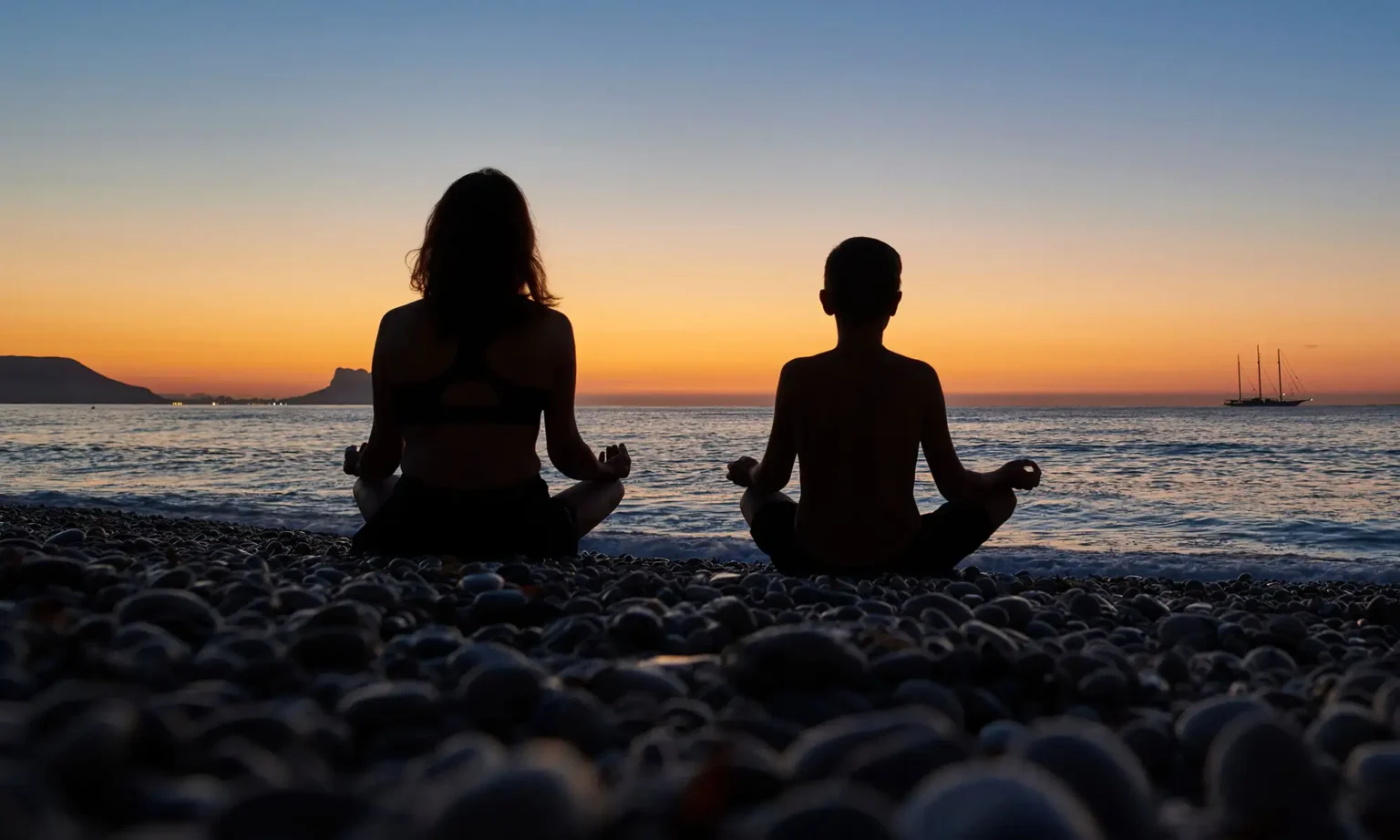 A female and a boy meditating near the sea | Mindfulness-Based Family Therapy at Transformation Health Services in Virginia Beach, VA