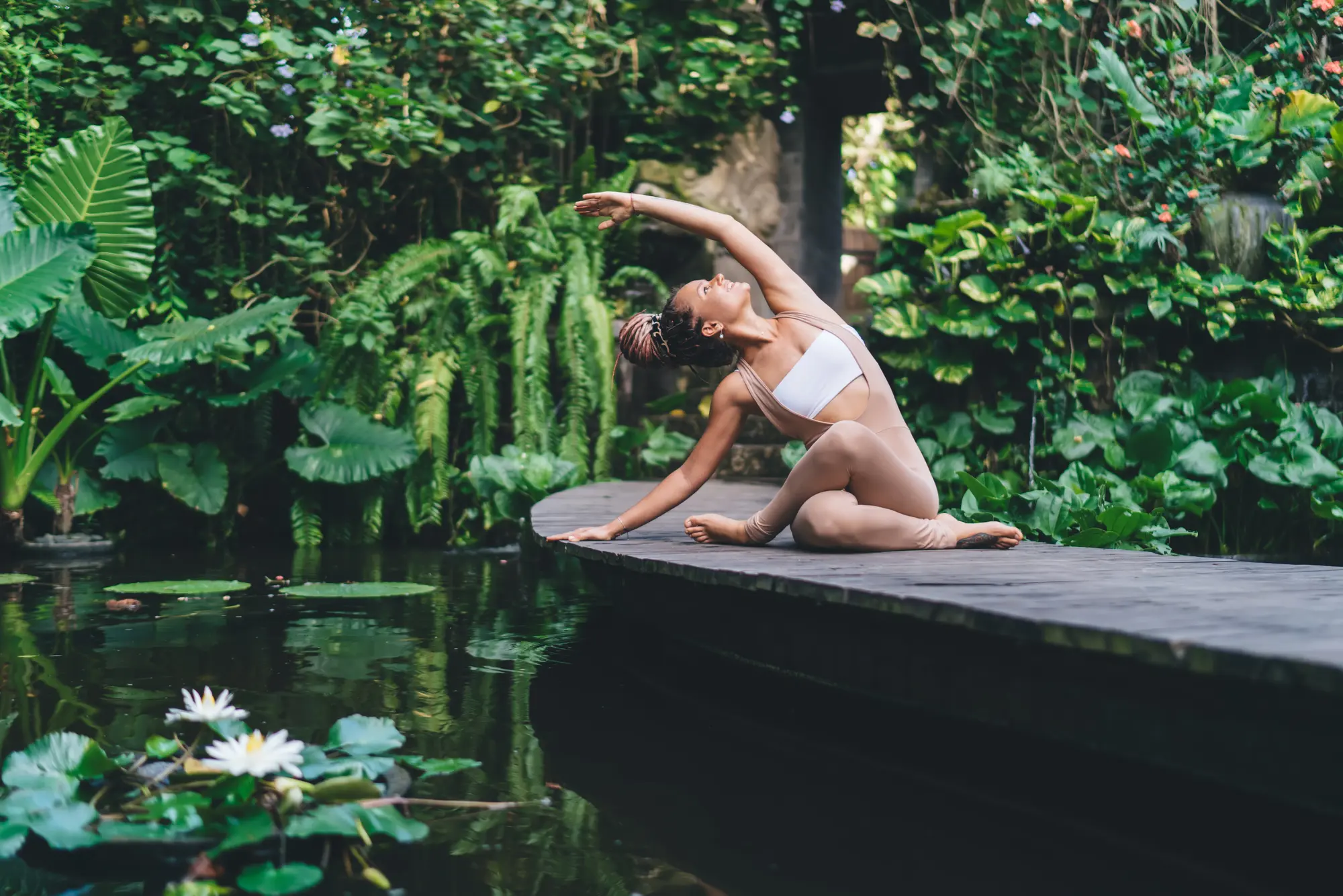 A female doing yoga near lake