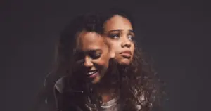 Woman showing mixed emotions representing bipolar disorder support with Transformation Health Services