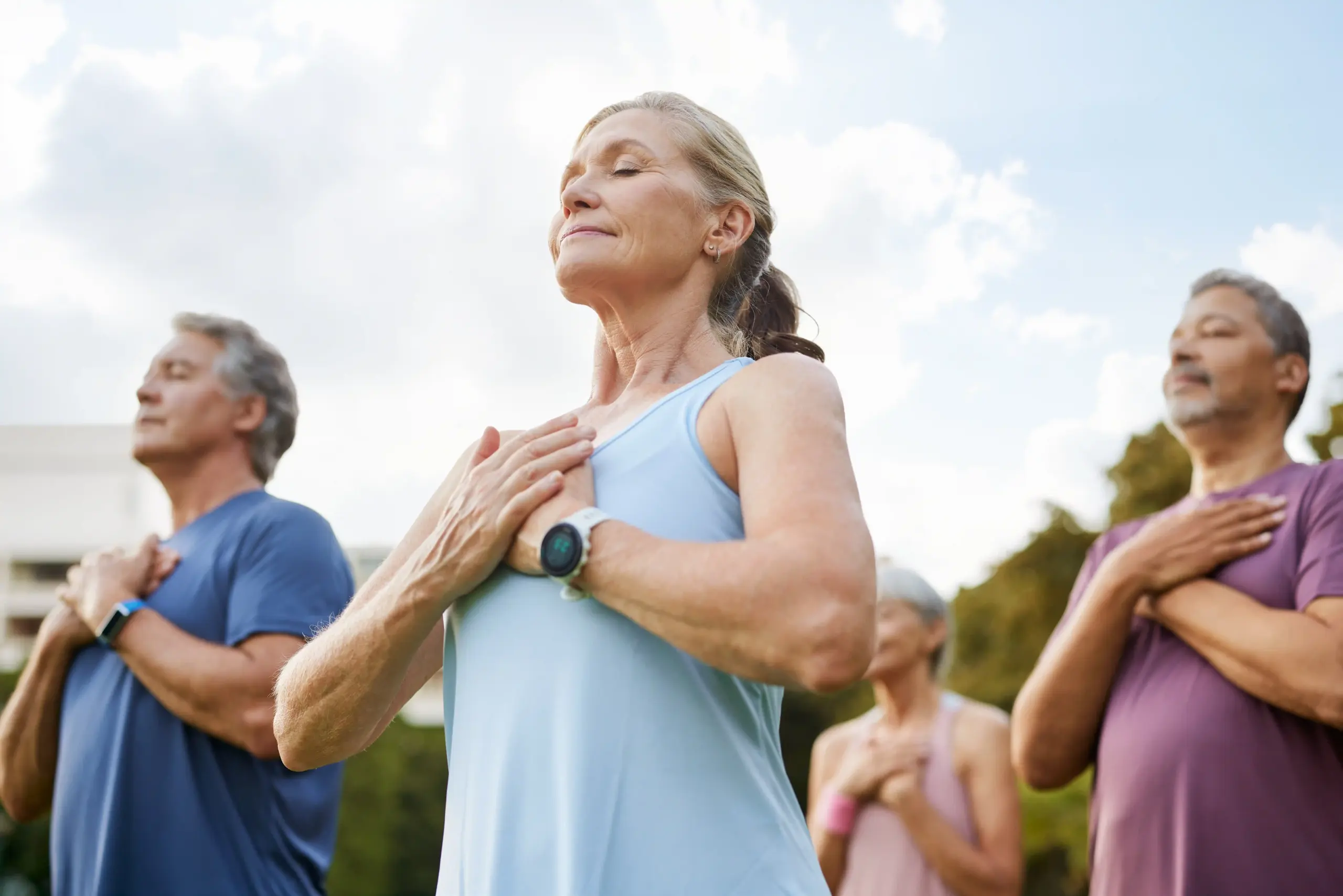 A group of old age people doing breathing exercises while holding hands on chest | Specialized Healing Modalities at Transformation Health Services in Virginia Beach, VA